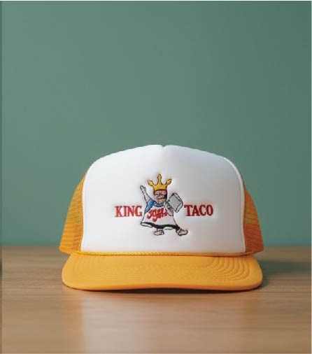 Orange and white foam trucker hat with the 'King Taco' cartoon logo patch.