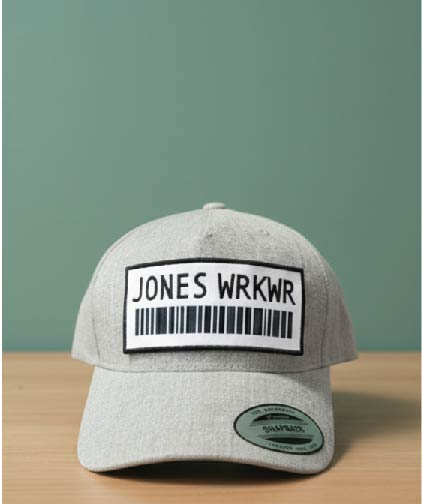 Grey structured curved bill cap with white 'JONES WRKWR' label and barcode patch.